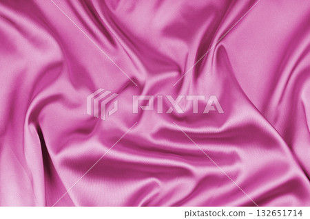 Crumpled, wrinkled pink colored glossy silk satin texture. Shiny smooth fabric with soft folds Crumpled, wrinkled pink colored glossy silk satin texture. Shiny smooth fabric with soft folds 132651714