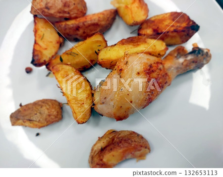 Delicious Fried Chicken Drumstick Served With Crispy Baked Potatoes for a Satisfying Meal Delicious Fried Chicken Drumstick Served With Crispy Baked Potatoes for a Satisfying Meal 132653113