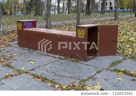 a bench with an open door in an autumn park 132653591