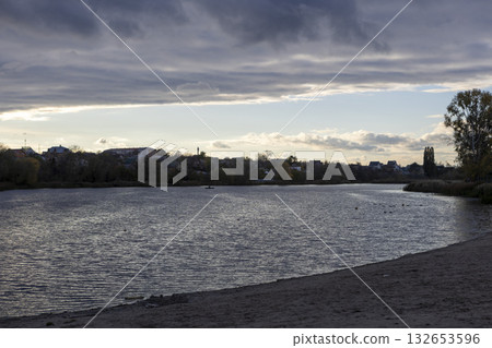 Cloudy sky over the river. Ripples on the water 132653596