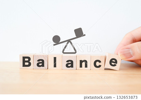 Illustration of a seesaw with wooden blocks showing balance. 132653873