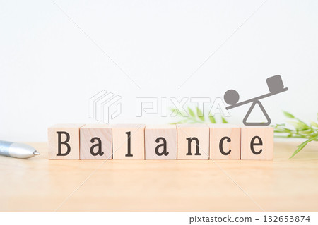 Illustration of a seesaw with wooden blocks showing balance. 132653874