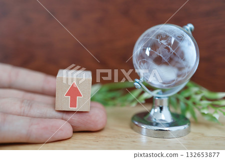 Global upward trend indicated by globe and upward arrow. 132653877