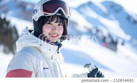 A young Japanese woman with short bob hair enjoying skiing on a snowy mountain 132654691