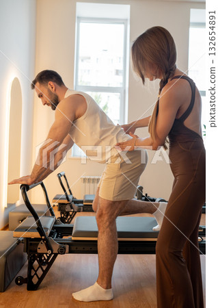 Instructor guides posture correction, Calm atmosphere with handson guidance for posture improvement 132654891