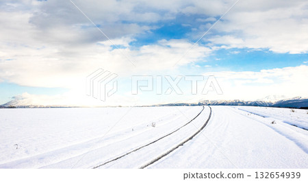 Snow-packed icy roads and scenery in Hokkaido in winter with a blue sky Snow-packed icy roads and scenery in Hokkaido in winter with a blue sky 132654939
