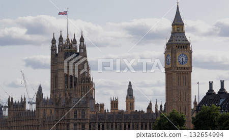 United Kingdom flag waving over Palace of Westminster with Big Ben in London 132654994