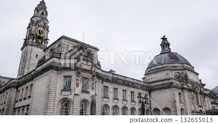 Cardiff City Hall clock tower rising majestically against a cloudy sky in Wales 132655013