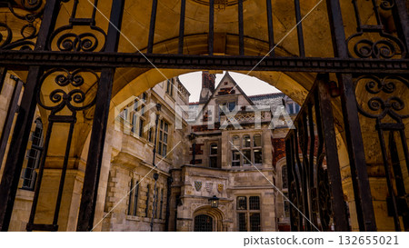 Wrought iron gate revealing the courtyard of a historic building in Cambridge Wrought iron gate revealing the courtyard of a historic building in Cambridge 132655021