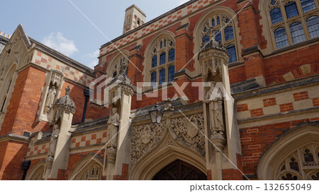 Statues adorning the brick facade of a historic building in Cambridge 132655049