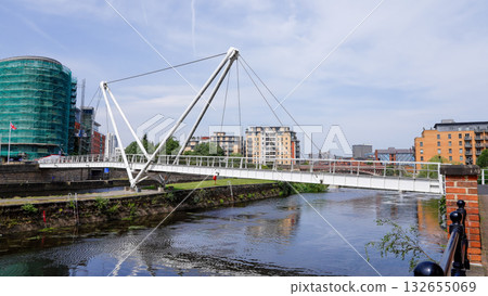 Modern pedestrian bridge crossing the River Aire in Leeds, UK 132655069