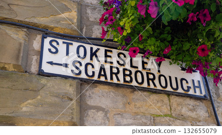 Road sign to Stokesley and Scarborough showing directions in Helmsley, North York Moors National Park 132655079