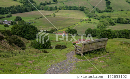 Empty bench overlooking green valley in North York Moors National Park, UK 132655102