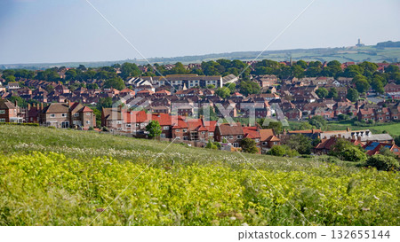 Whitby cityscape overlooking rooftops and green fields in North York Moors National Park 132655144