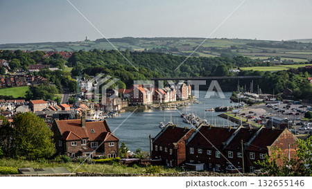 Whitby harbor with boats and red brick houses in North York Moors National Park, UK 132655146