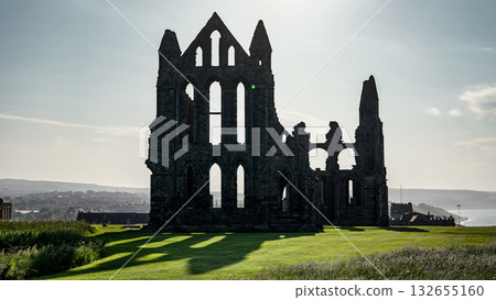 Whitby Abbey rising on a green hill in North York Moors National Park Whitby Abbey rising on a green hill in North York Moors National Park 132655160