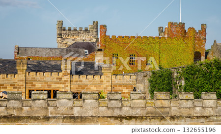 Whitby Abbey rising behind stone wall in North York Moors National Park 132655196