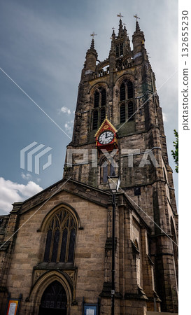 Newcastle Cathedral showing its clock tower rising towards a cloudy sky Newcastle Cathedral showing its clock tower rising towards a cloudy sky 132655230
