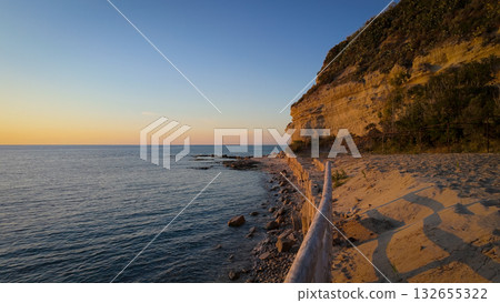 Wooden fence running along the beach at sunset in Tropea, Calabria, Italy Wooden fence running along the beach at sunset in Tropea, Calabria, Italy 132655322