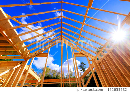 Workers construct building frame with wooden beams roof frame trusses Workers construct building frame with wooden beams roof frame trusses 132655382