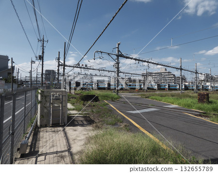 Under the blue sky, trains lined up at JR Kamata marshalling yard and a complex web of electric wires and overhead lines Under the blue sky, trains lined up at JR Kamata marshalling yard and a complex web of electric wires and overhead lines 132655789