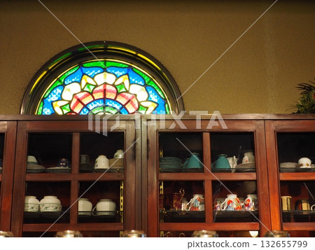 Rainbow-colored stained glass: antique coffee shop cupboard 132655799