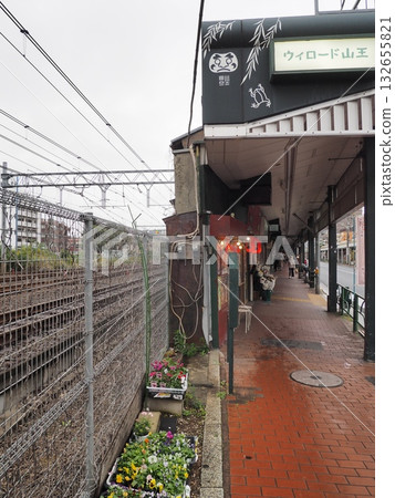 The entrance to the Willow Road Sanno shopping street next to the railroad tracks and the area under the elevated tracks leading to the red brick walkway 132655821