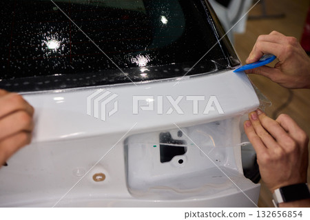 Applying a Protective Film on the Surface of Your Car for Enhanced Durability and Shine 132656854