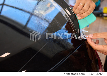 Applying a Protective Film on the Surface of Your Car for Enhanced Durability and Shine 132656920