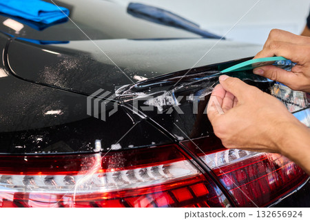 Applying a Protective Film on the Surface of Your Car for Enhanced Durability and Shine 132656924