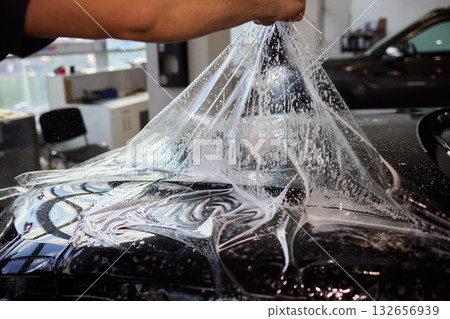 Applying a Protective Film on the Surface of Your Car for Enhanced Durability and Shine 132656939