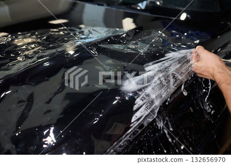 Applying a Protective Film on the Surface of Your Car for Enhanced Durability and Shine 132656970