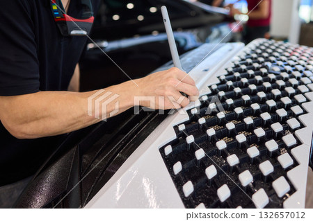Applying a Protective Film on the Surface of Your Car for Enhanced Durability and Shine Applying a Protective Film on the Surface of Your Car for Enhanced Durability and Shine 132657012