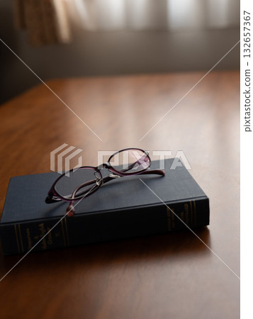 Glasses on books 132657367