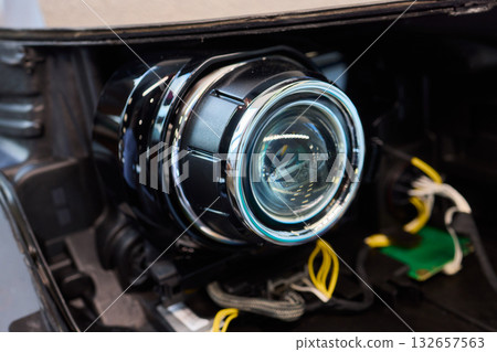 Careful precision is essential when installing a car headlight assembly for optimal performance 132657563