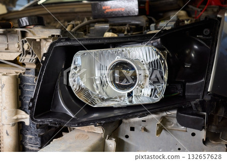 Careful precision is essential when installing a car headlight assembly for optimal performance Careful precision is essential when installing a car headlight assembly for optimal performance 132657628