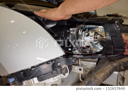 Careful precision is essential when installing a car headlight assembly for optimal performance Careful precision is essential when installing a car headlight assembly for optimal performance 132657640
