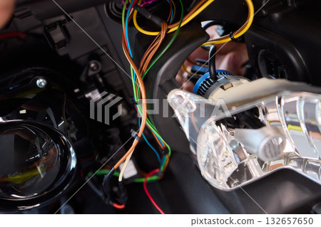 Careful precision is essential when installing a car headlight assembly for optimal performance Careful precision is essential when installing a car headlight assembly for optimal performance 132657650