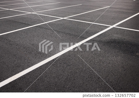 Reflective wet asphalt grid, Urban nighttime scene with textured asphalt and reflections, Cityscape at night showing glossy wet road surfaces and geometric line Reflective wet asphalt grid, Urban nighttime scene with textured asphalt and reflections, Cityscape at night showing glossy wet road surfaces and geometric line 132657702