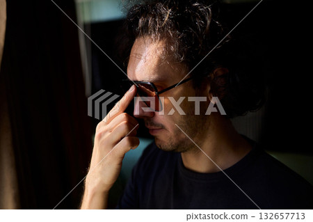 Nighttime artistic portrait, Creative director by window scene, Moody cinematic image of nighttime scene, Reflective lenses capturing introspective moments at night 132657713