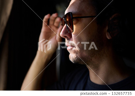 Nighttime artistic portrait, Creative director by window scene, Moody cinematic image of nighttime scene, Reflective lenses capturing introspective moments at night Nighttime artistic portrait, Creative director by window scene, Moody cinematic image of nighttime scene, Reflective lenses capturing introspective moments at night 132657735