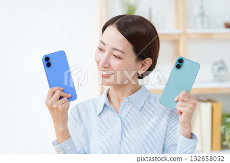 A woman with multiple smartphones A woman with multiple smartphones 132658052