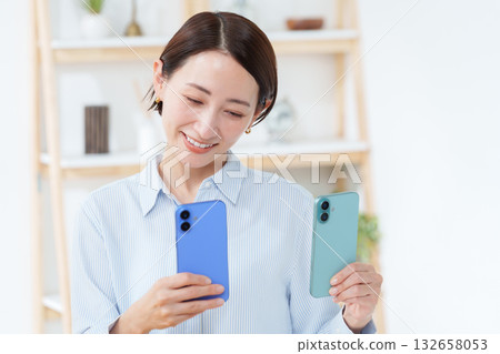 A woman with multiple smartphones A woman with multiple smartphones 132658053