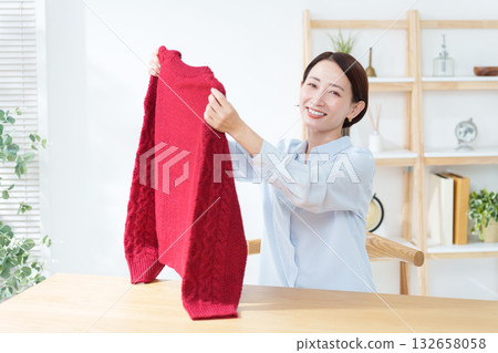 A woman taking out a sweater for a change of clothes 132658058