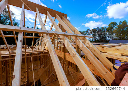 Wooden beams trusses form structure of house with joist installation 132660744