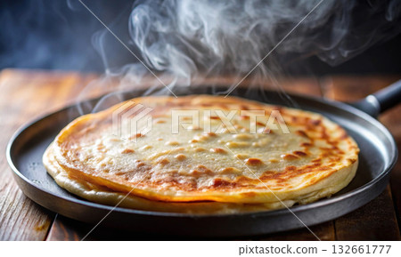 Close-up of a delicious, freshly cooked pancake on a hot frying pan 132661777