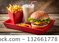 Fast-food meal with a cheeseburger, French fries, and a milkshake 132661778