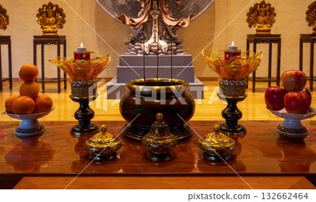 Offerings and incense burner before the Buddha Offerings and incense burner before the Buddha 132662464