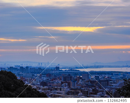 Dawn in Kobe City. View from the hilltop in Okamoto, Higashinada Ward, across Osaka Bay to downtown Kobe and Osaka City. 132662495