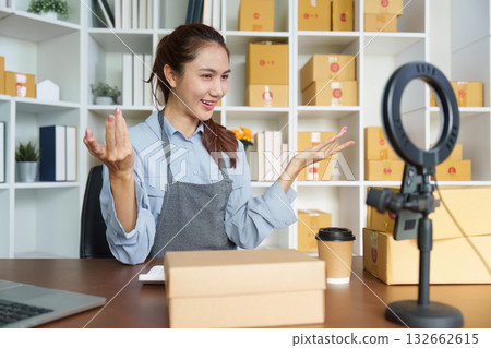 Small Business Engagement. Young woman live-streaming product presentation with ring light. 132662615